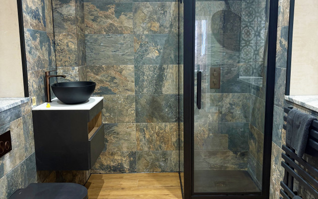 A modern bathroom layout showcasing a shower, toilet, and basin.