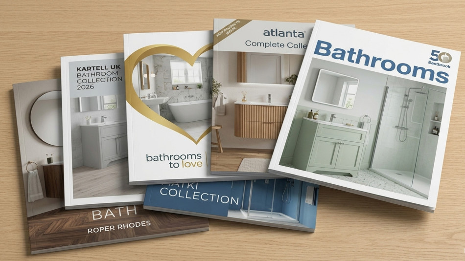 A selection of bathroom brochures on a wooden table, showcasing various bathroom design inspirations and collections.